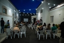 Cortile esterno di sera con seie e persone, durante un evento serale