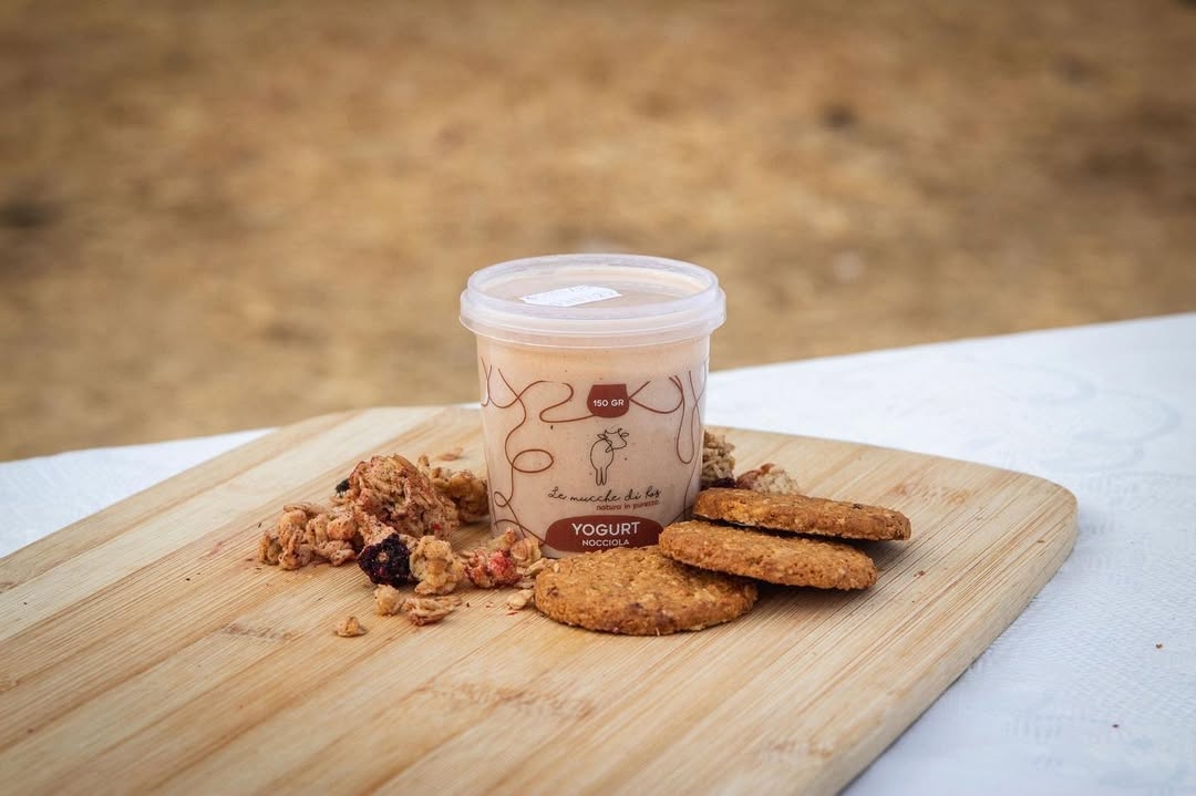 Yogurt alla nocciola Le Mucche di Ros presentato su un tagliere con biscotti e muesli