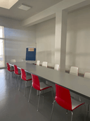 3. Sala
3. Spazioso e luminoso locale, nel quale è possibile notare la presenza di un numero elevato di sedute e di un tavolo particolarmente lungo. Inoltre, in questa sala, è presente una lavagna a fogli mobili.