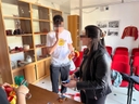 Lo spazio di Galattica allestito dai giovani Chieutini Tre ragazzi di cui due in primo piano all'interno di una sala con sedie rosse e teche di vetro.